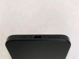 a close up of the back of a black iphone with a white background