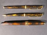 three different types of pens are lined up on a table