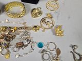 many different types of jewelry on display on a table