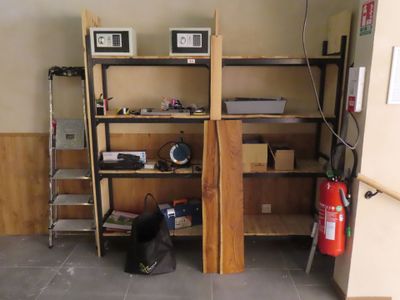 a room with a shelf and a fire extinguisher in it