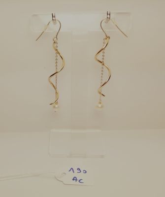 a pair of earrings on a display stand with a price tag
