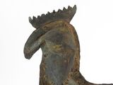 statue of a bird with a crown on its head on a white surface