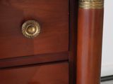 a close up view of a wooden dresser with brass handles