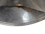 a close up of a metal object on a white surface
