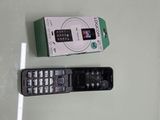 a remote control sitting next to a box on a table