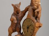 a wooden clock that has a bear and a bear cub on it