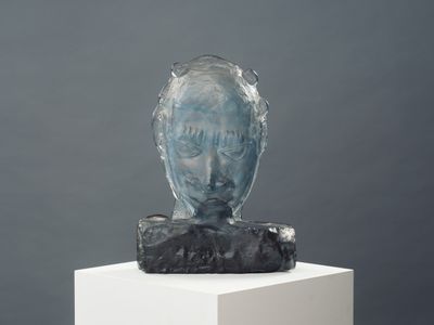 a sculpture of a man ' s head on a pedestal