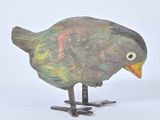 a small bird that is standing on a white surface