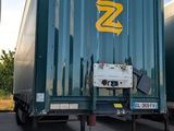 two semi trucks parked next to each other in a parking lot