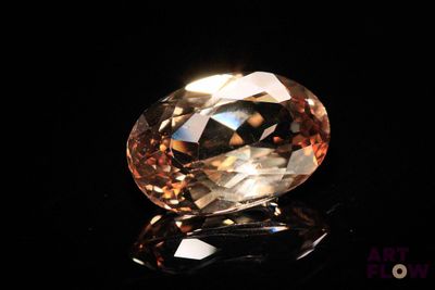 a close up of a fancy diamond on a black surface