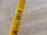 yellow pencil with a sticker on it sitting on top of a marble table