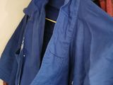 a blue shirt hanging on a clothes rack in a closet