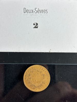 an image of a gold coin sitting on top of a black table