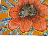 leopard in a flower on an orange background with blue and yellow leaves