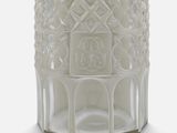a white vase with a design on it on a white surface