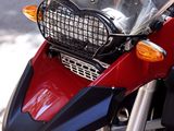 a red and black motorcycle parked on the side of the street