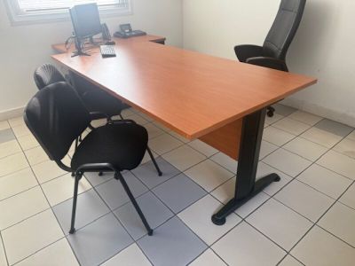 a desk with a chair and a computer on it