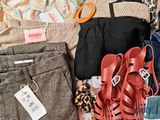 a pile of clothing and a pair of shoes on the floor