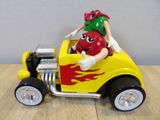 a toy car with a man riding in the back of it