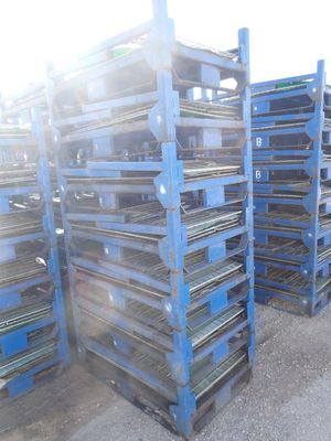 many pallets that are stacked up on the ground