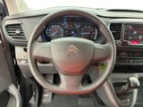 the interior of a car with a steering wheel and dashboard controls