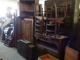 a room filled with lots of wooden furniture and other items