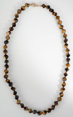 a necklace made of tiger ' s eye beads with a gold clasp