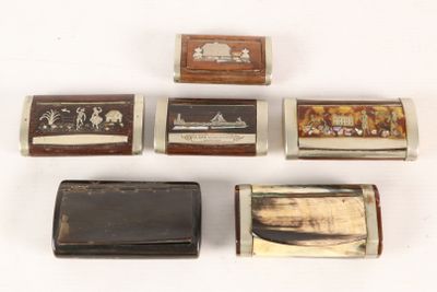 several different types of cigarette cases are lined up on a white surface