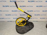 a yellow and black metal detector sitting on a black bag