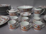 a lot of plates and cups that are sitting on a table