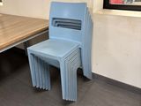 a blue chair sitting next to a table in a room