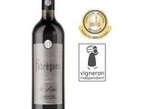 a bottle of red wine with a gold medal around it