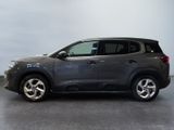 the grey suv is parked in a room with a gray floor