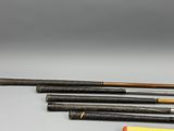 four different types of baseball bats are lined up on a table