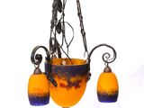 un lustre en verre orange et bleu suspendu au plafond