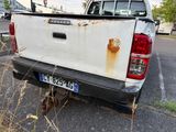 a white pick up truck parked on the side of the road
