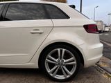 a white car that is parked on the side of the road