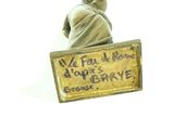 a statue of a man holding a sign that says we put all hope in the day ' s