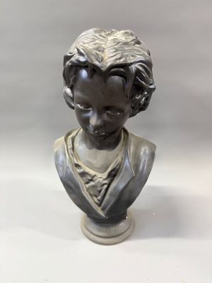 bust of a young boy with curly hair and a collared shirt