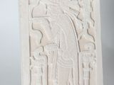 pair of white ceramic sculptures of a man and woman on a pedestal