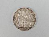 a close up of a coin on a white surface