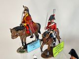 three figurines of soldiers riding horses on display