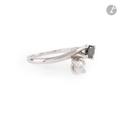 a close up of a ring with a black diamond on a white background