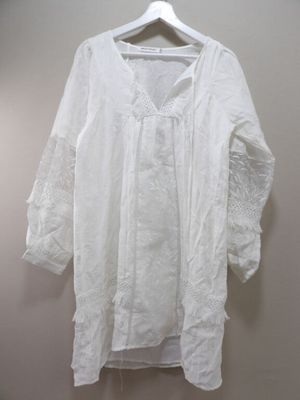 an image of a white shirt hanging on a hanger on a wall