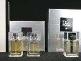 three bottles of perfume sitting next to each other on a table