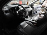 the interior of a car with black leather seats and a steering wheel