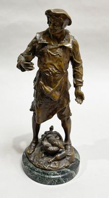 bronze statue of a man with a dog on a marble base