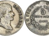a silver coin with the head of a woman in profile