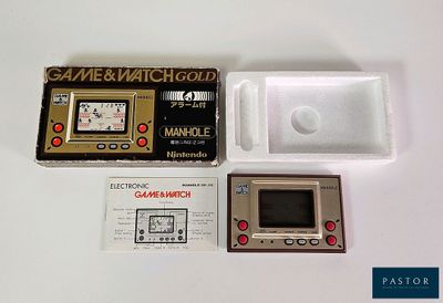 a game and watch set up on a white table