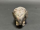 an image of a silver elephant figurine sitting on top of a table